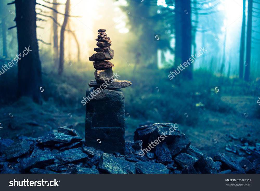 stock-photo-piled-good-luck-stones-showing-the-way-for-lost-ones-in-enchanted-forest-beautiful-mysterious-625288559.jpg